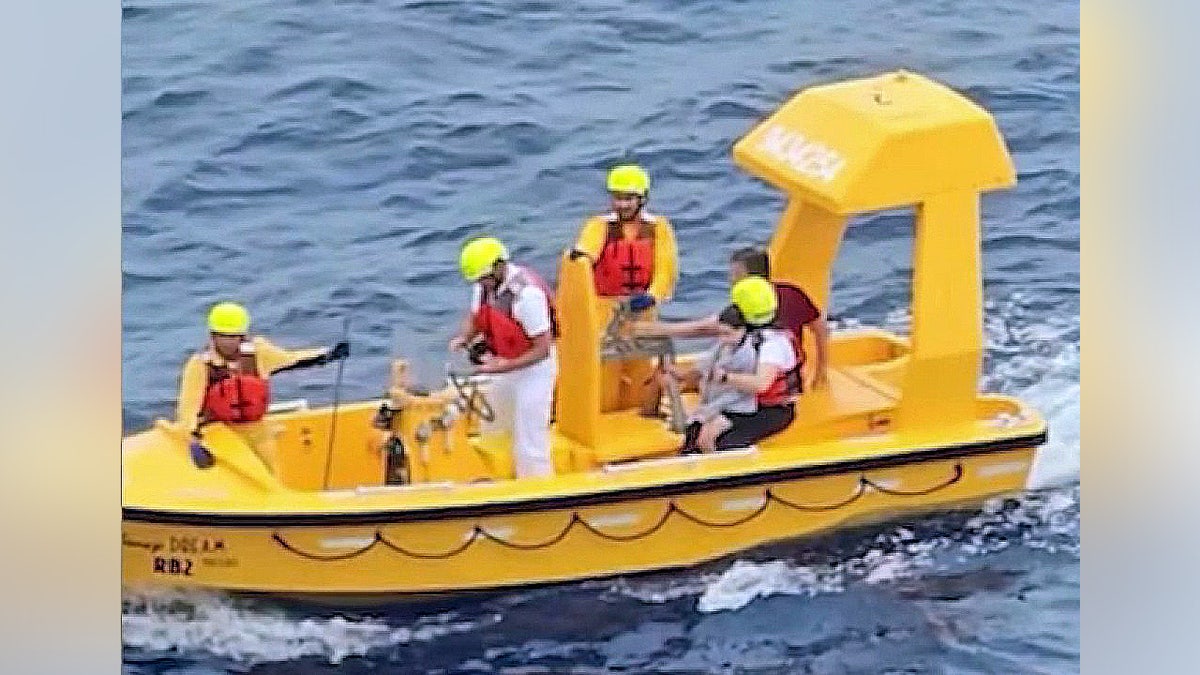A small boat carrying the father and 5-year-old girl after she fell from a Disney Dream Cruise