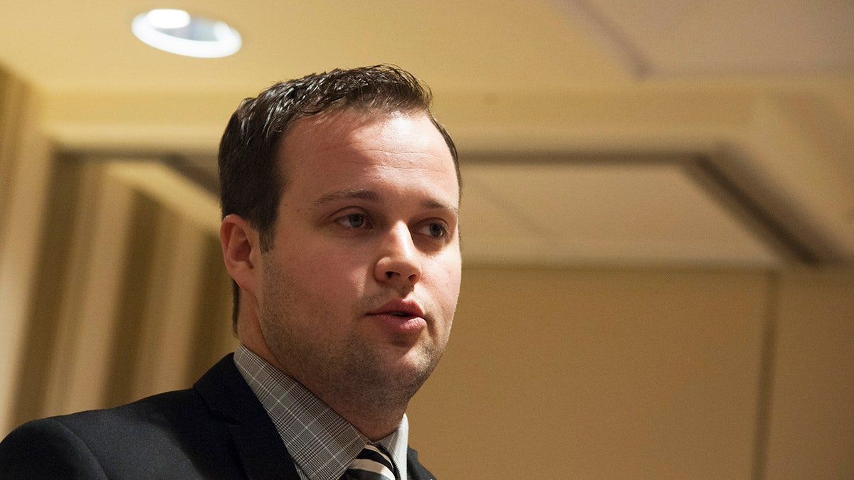 Josh Duggar speaking on stage.