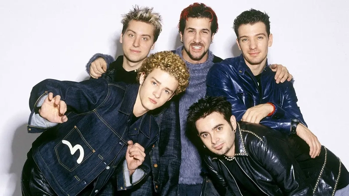 Los miembros de la banda *NSYNC posando juntos con atuendos a juego en la ciudad de Nueva York.
