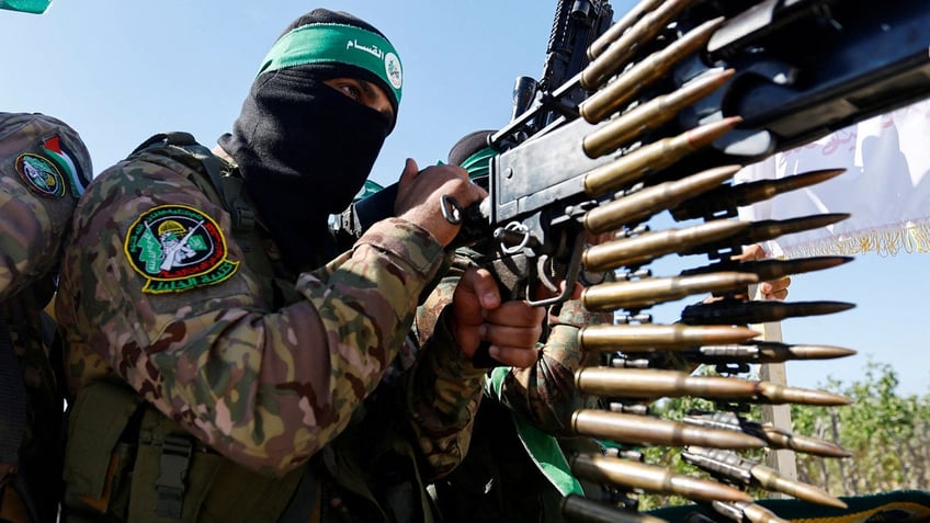 Een Palestijnse strijder van de gewapende vleugel van Hamas neemt deel aan een militaire parade