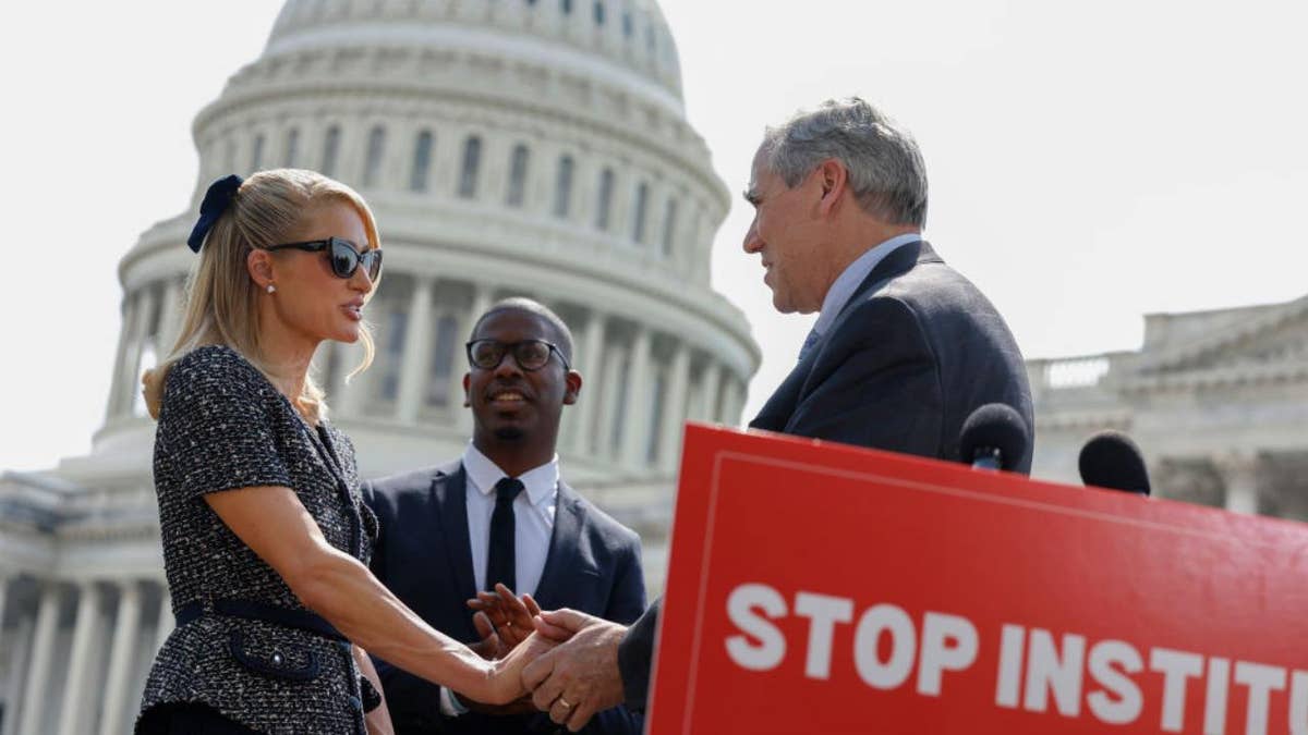 Paris Hilton with Sen. Merkley at press event on Capitol Hill
