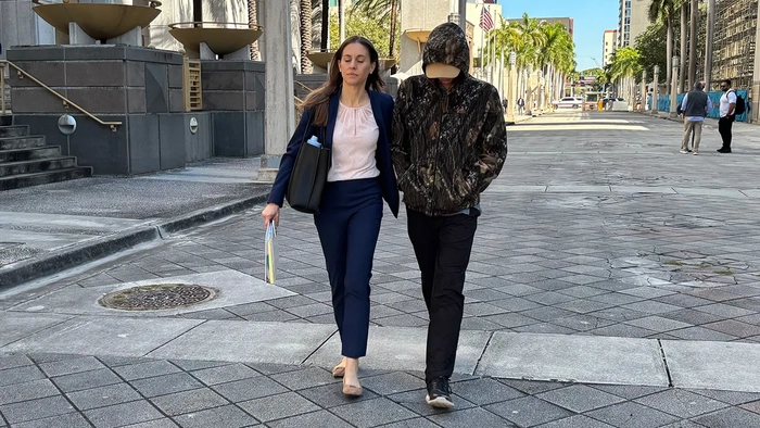 Сводный брат Анны Кепнер и его адвокат гуляют у здания федерального суда в Майами.