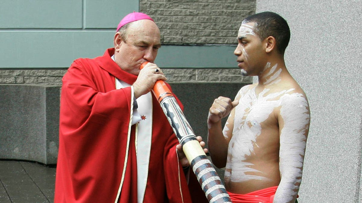 Bishop Christopher Saunders of Broome tries to play a digeridoo