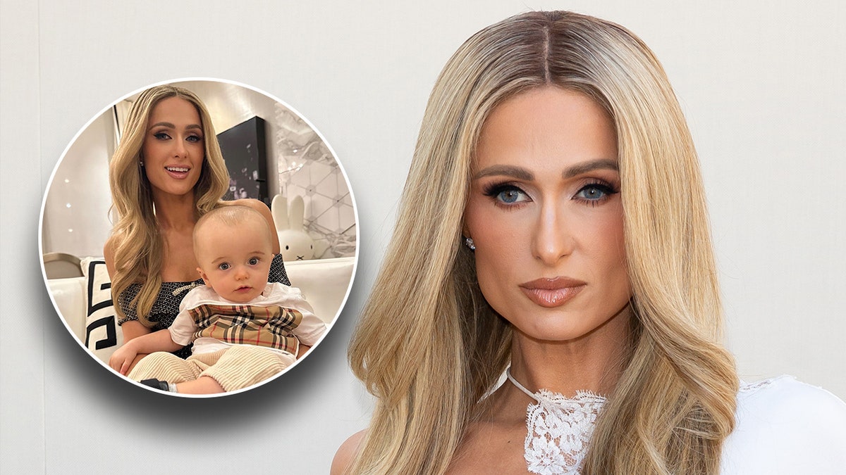 Paris Hilton con un top blanco luce seria en la alfombra insertando una foto de ella sosteniendo a su hijo Phoenix en su regazo