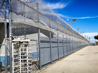 Prison fences and turnstile of Mira Loma Detention Center in Lancaster California.