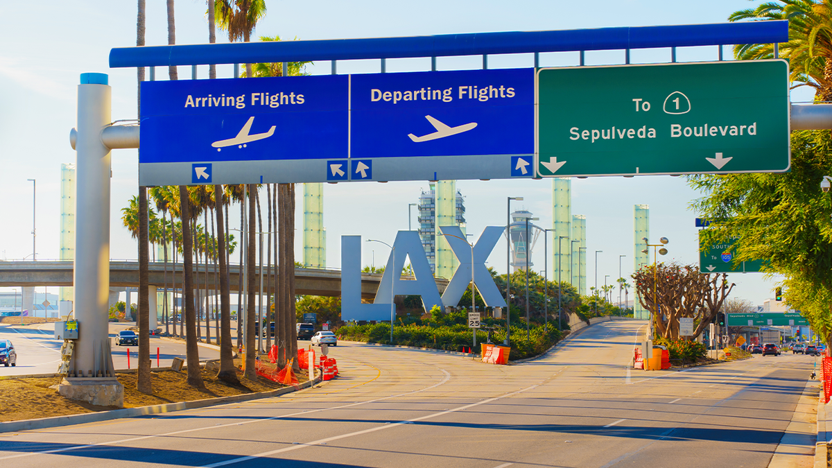 Hollywood piano teacher allegedly flees country after sexual abuse conviction involving teen signs for arrivign and departing flights at the entrance of LAX airport in los angeles
