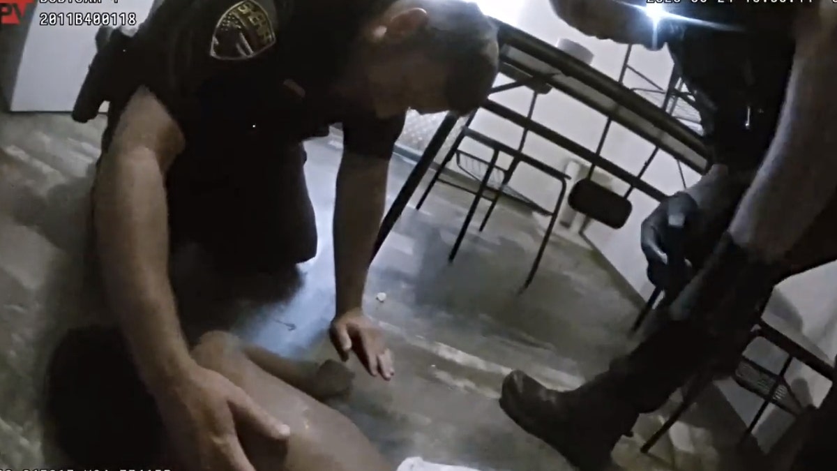 Two deputies administer CPR to the 2-year-old victim, who wakes and coughs