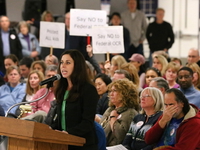 Tracey Salvatore, of Schaumburg, speaks Dec. 2 during a special District 211 board meeting at Conant High School in Hoffman Estates to consider a setlement in the case of a transgender student seeking locker room access. (Chris Sweda/Chicago Tribune/TNS)