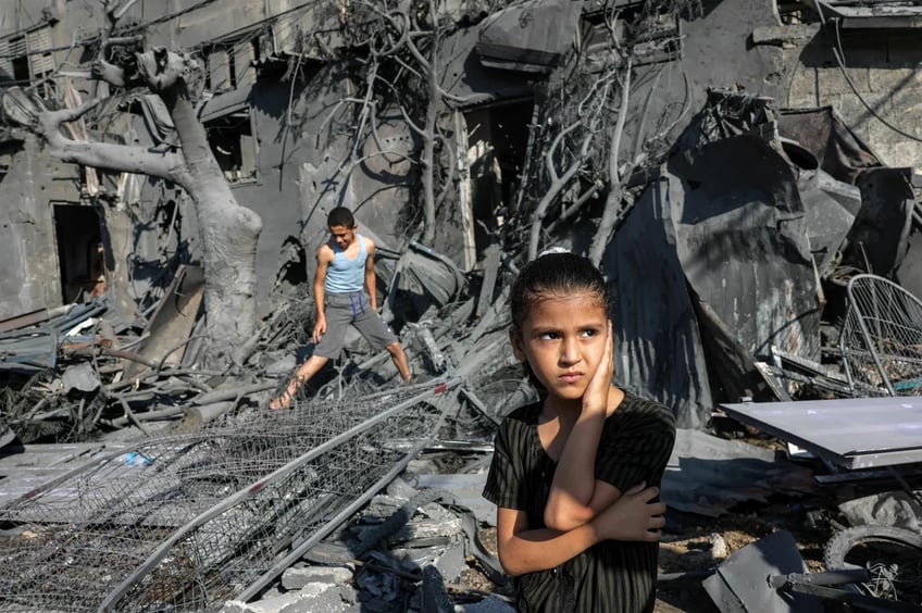 Children in the rubble of buildings after a bombing in Gaza.